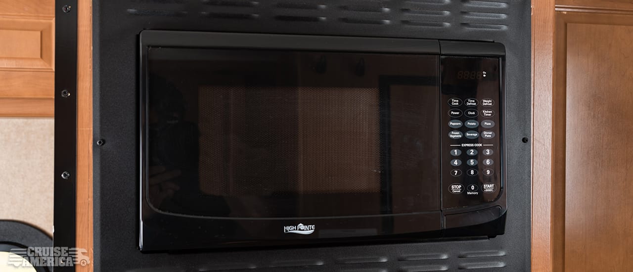 Microwave next to upper cabinet