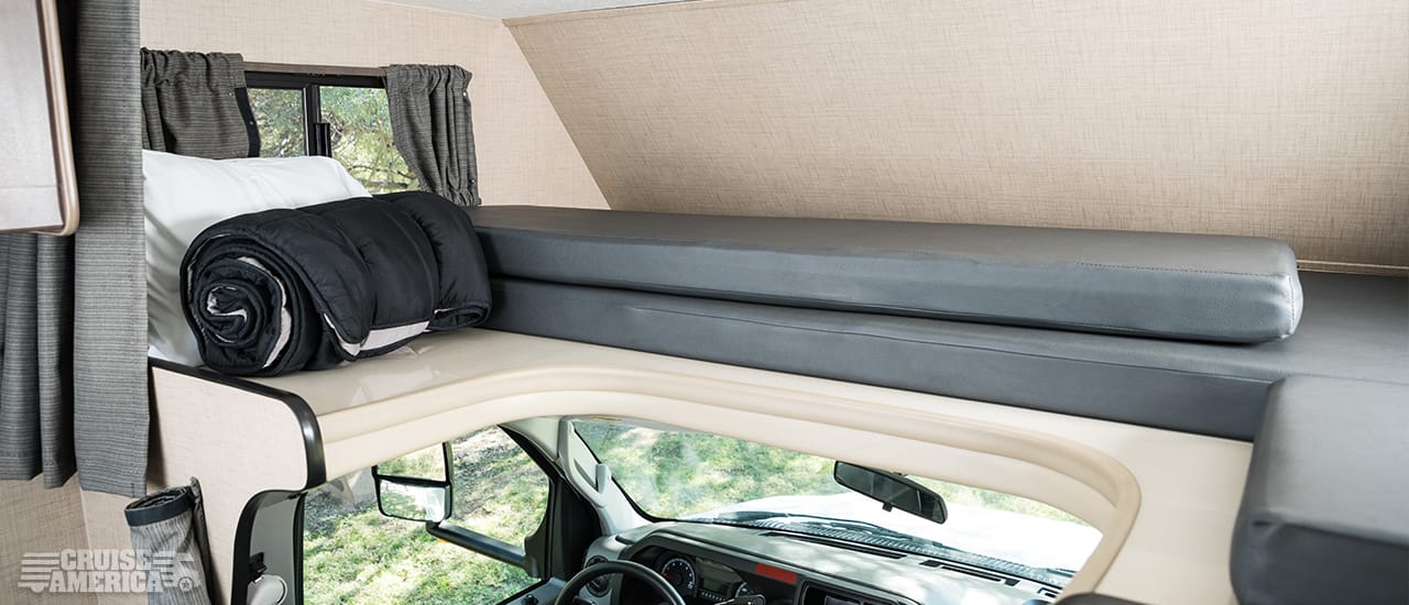 Loft over drivers cab, showing storage of sleeping gear and cusions
