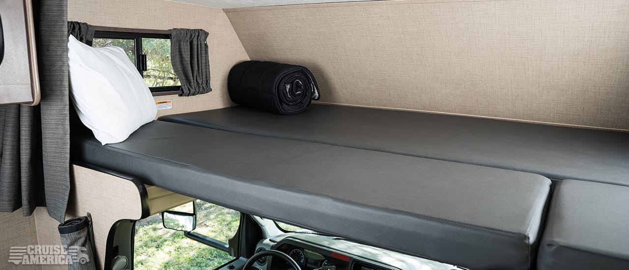 Loft over drivers cab, showing bed arrangement of sleeping gear and cusions