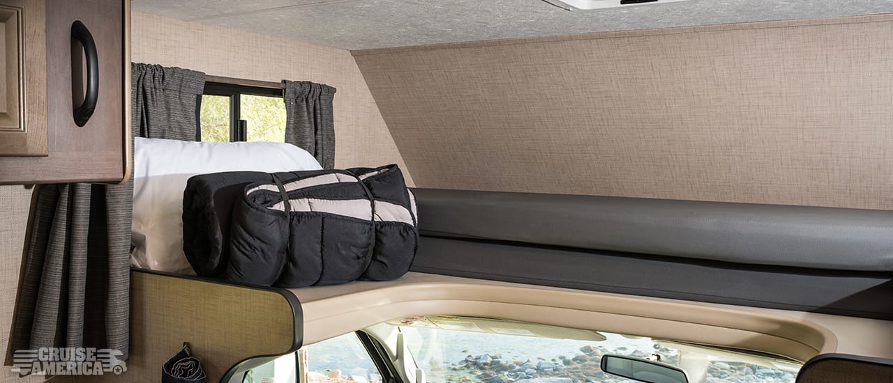 Loft over drivers cab, showing storage of sleeping gear and cusions