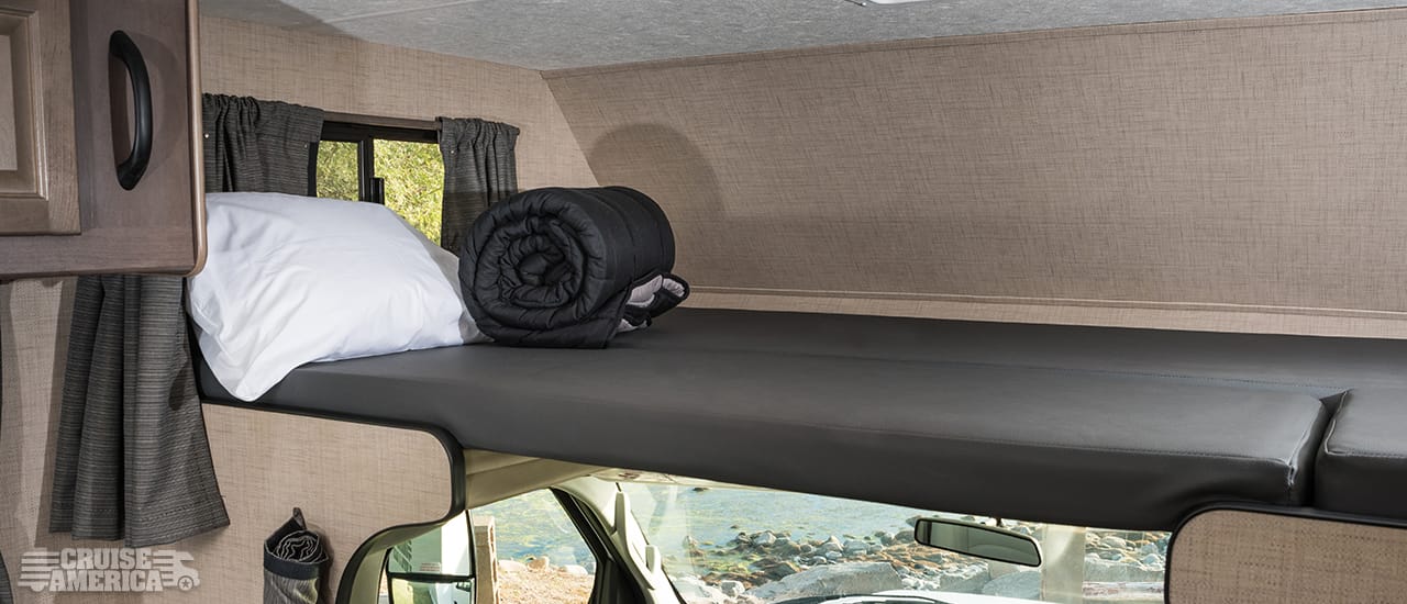 Loft over drivers cab, showing bed arrangement of sleeping gear and cusions